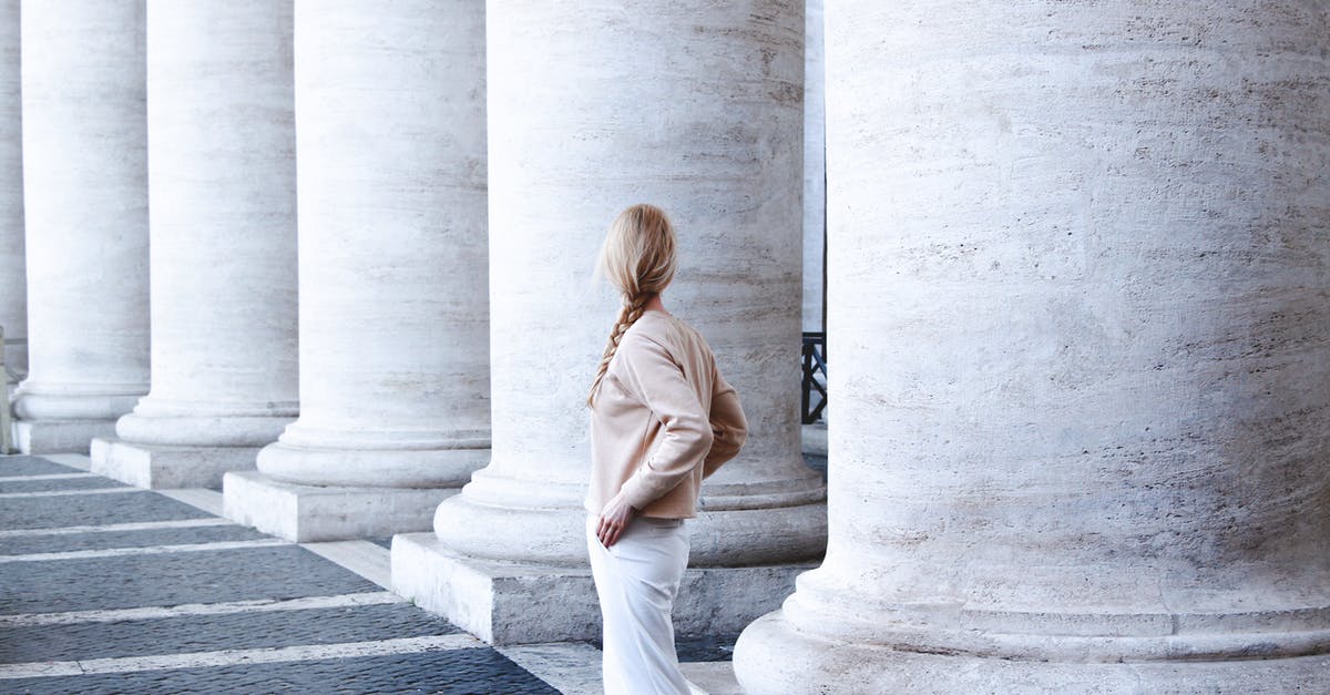 traveling and returning back to italy - Photo of Woman Standing Beside Concrete Pillar