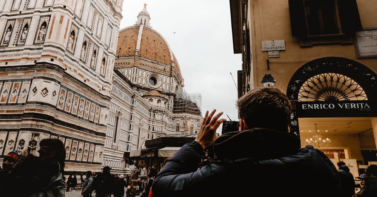 traveling and returning back to italy - A Man Taking Photo of the Building