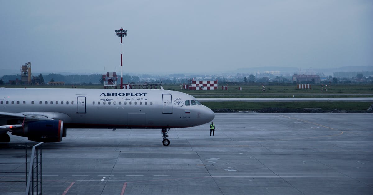 Traveling by Air with a Large "Husky" Mobile Job Box - White Aeroflot Passenger Plane on Airport