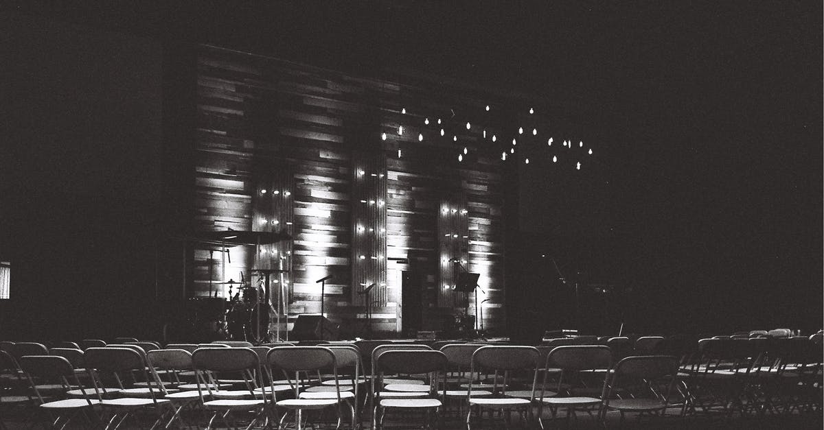 Traveling for a Conference - Grayscale Photography Of Chairs In An Auditorium