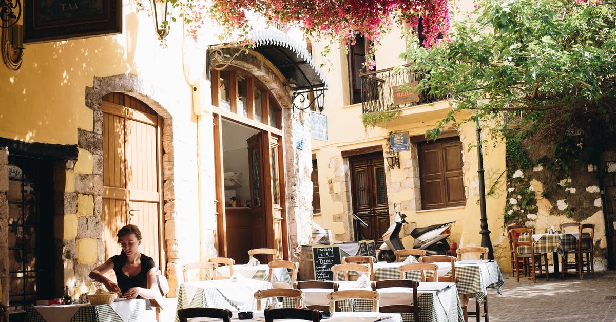 Traveling from Anaklia Georgia to Greece? [closed] - Woman Wearing Black Scoop-neck Cap-sleeved Blouse Eating on Cafeteria With White Table Arrangements