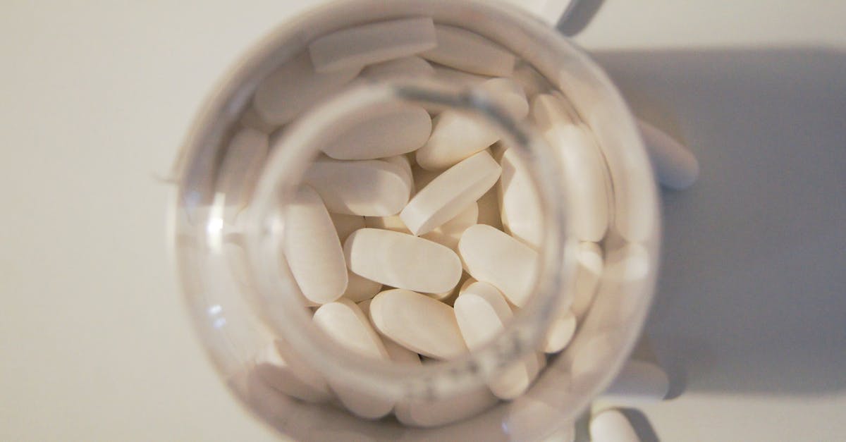 Traveling from Europe to Beijing, China with prescription drugs - White Medication Pills in Clear Glass Jar