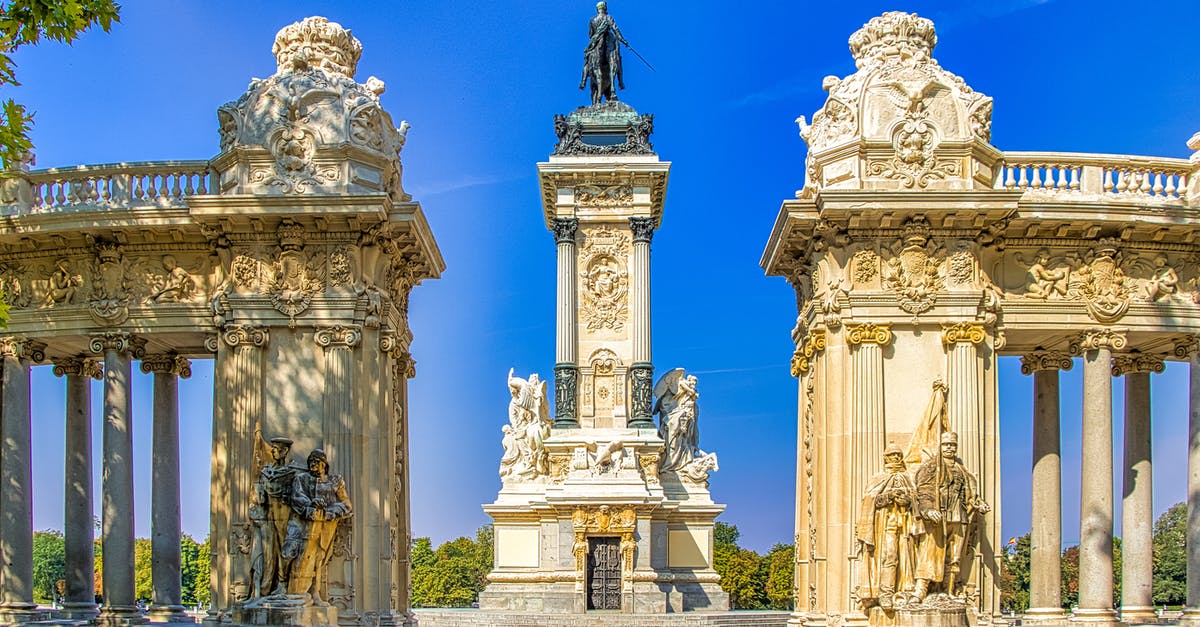 Traveling from Frankfurt to Madrid on a single-entry Schengen visa - White and Black  Concrete Statues Under Blue Sky