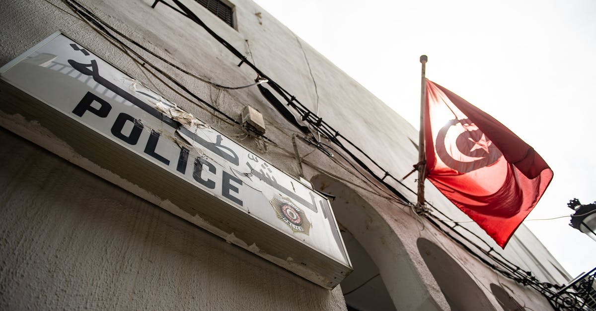 Traveling from LAX to Cape Town with Turkish Airlines - From below exterior of concrete house with arched elements and Police signboard and hanging flag of Turkey located on street in city