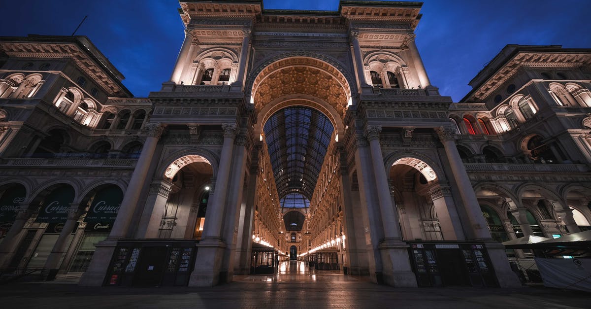 Traveling from Peru to Argentina - where should I buy Pesos? - From below of ancient famous Galleria Vittorio Emanuele II shopping mall with arched passage and ornamental ceiling located on square in Milan against night sky