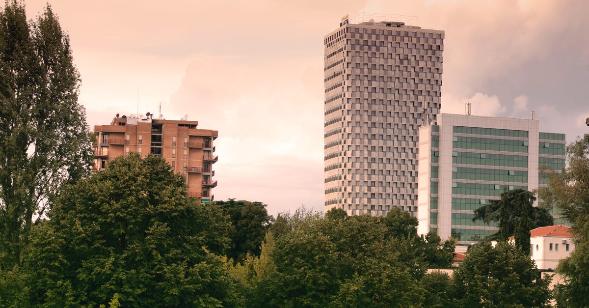 Traveling from Tirana, Albania to Korce, Albania [closed] - High Rise Buildings Near Green Leaf Trees Under White Sky during Daytime