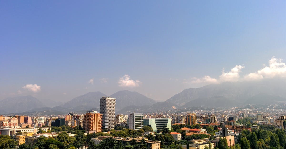 Traveling from Tirana, Albania to Korce, Albania [closed] - Grey Concrete Building in the Middle of the City Under Blue Sky