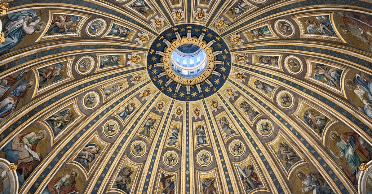 Traveling in Algeria from Europe [duplicate] - From below amazing dome ceiling with ornamental fresco paintings and stucco elements in St Peters Basilica in Rome