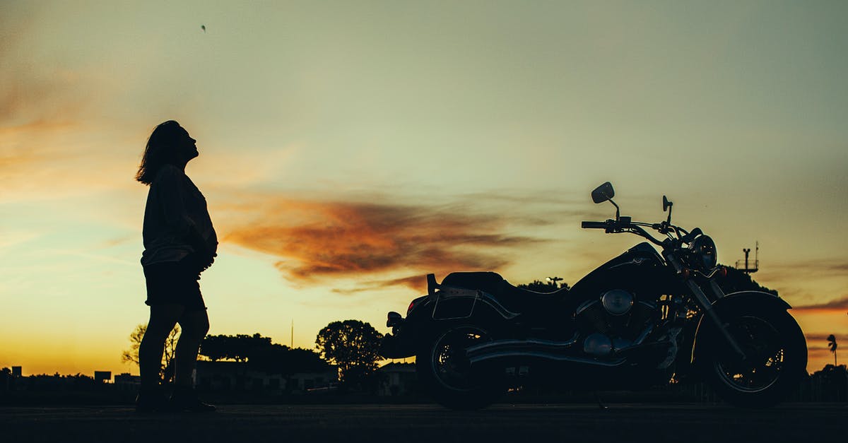 Traveling on H4 visa in pregnancy - Silhouette of Pregnant Woman Near Motorcycle during Sunset