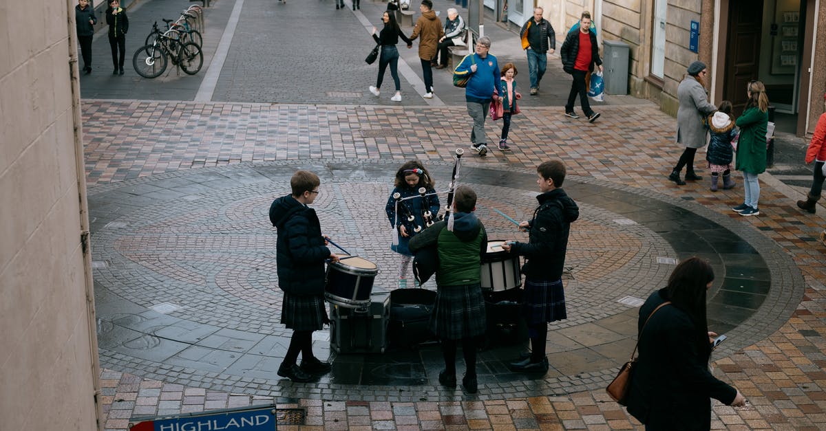 Traveling right after applying for UK visa (Global Talent Visa) - Scottish teenage musicians wearing traditional clothes and playing drums and bagpipe on street on autumn day