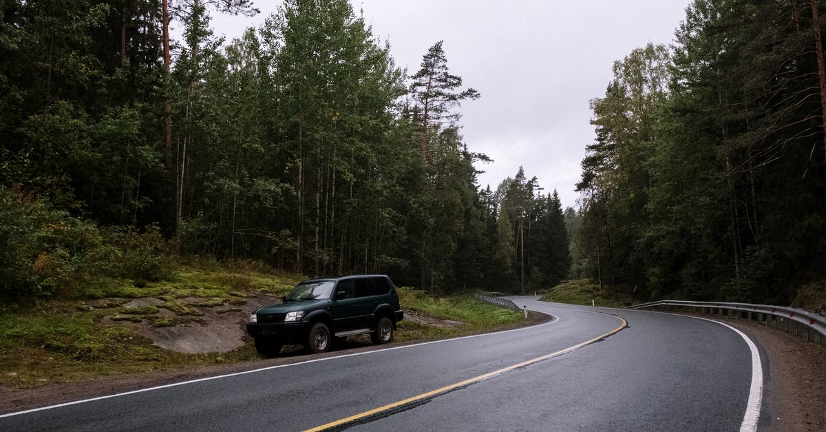 Traveling the Camino Trail during Covid - Black Suv on Roadside Between Green Trees