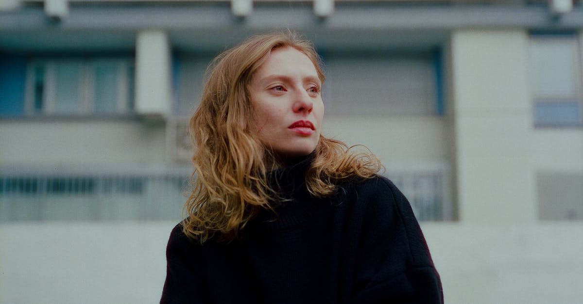 Traveling to France before date of the long sejour visa - Redhead Woman with Long Wavy Hair Standing Before Residential Building