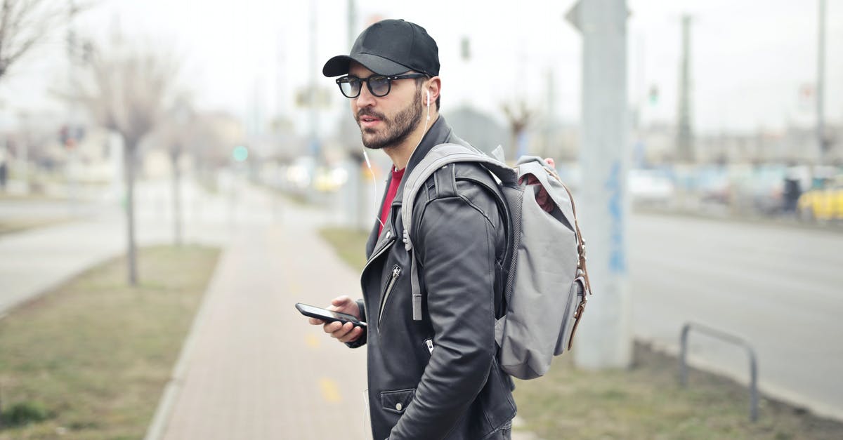 Traveling to Seoul, phone questions - Man Wearing Black Leather Jacket Holding Smartphone