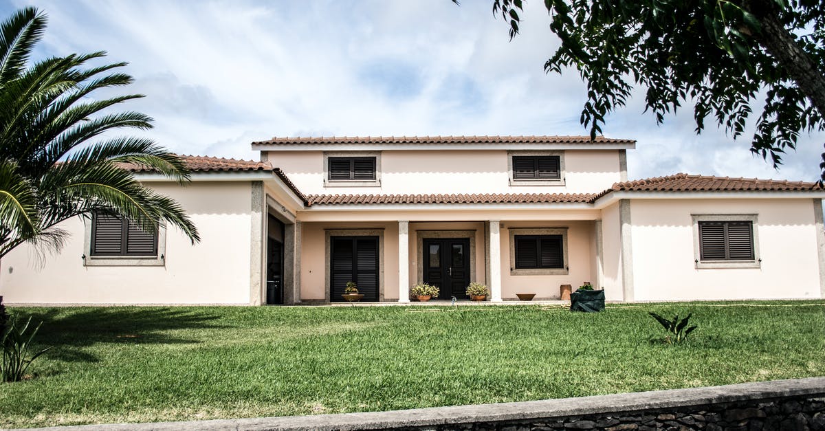 Traveling with a residence card - White Concrete House Under Cloudy Sky