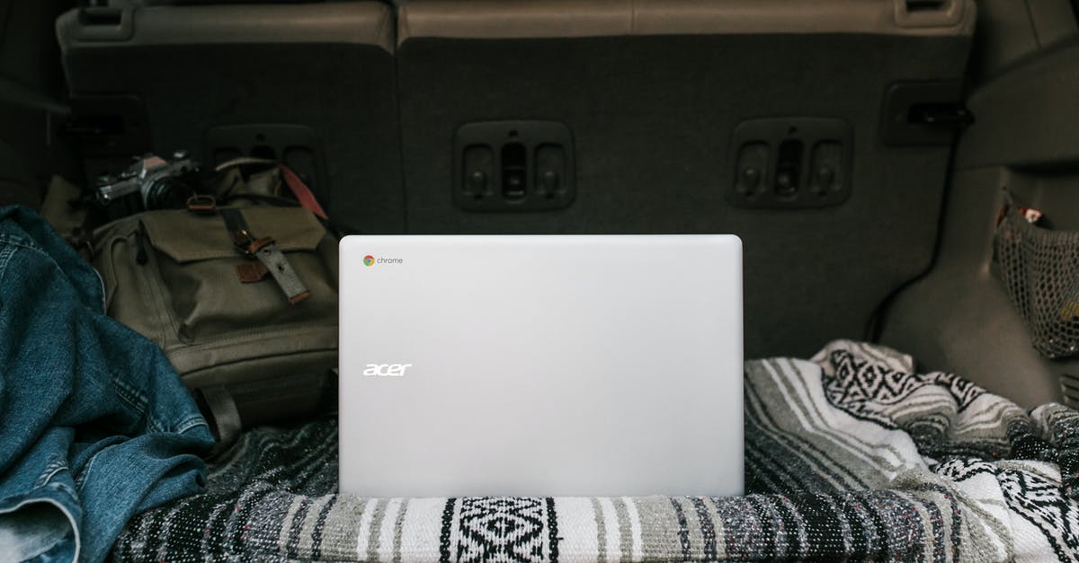 traveling with electronics - White Asus Laptop on Gray Car Seat