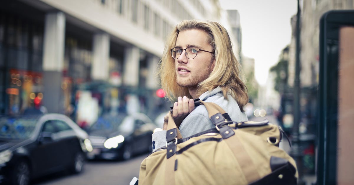 Traveling within Schengen while waiting for EEA residence card? - Man Holding His Duffel Bag