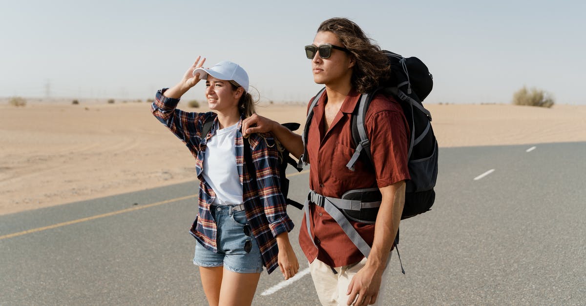Travelling as unmarried couple in Dubai - Backpackers Walking on the Road