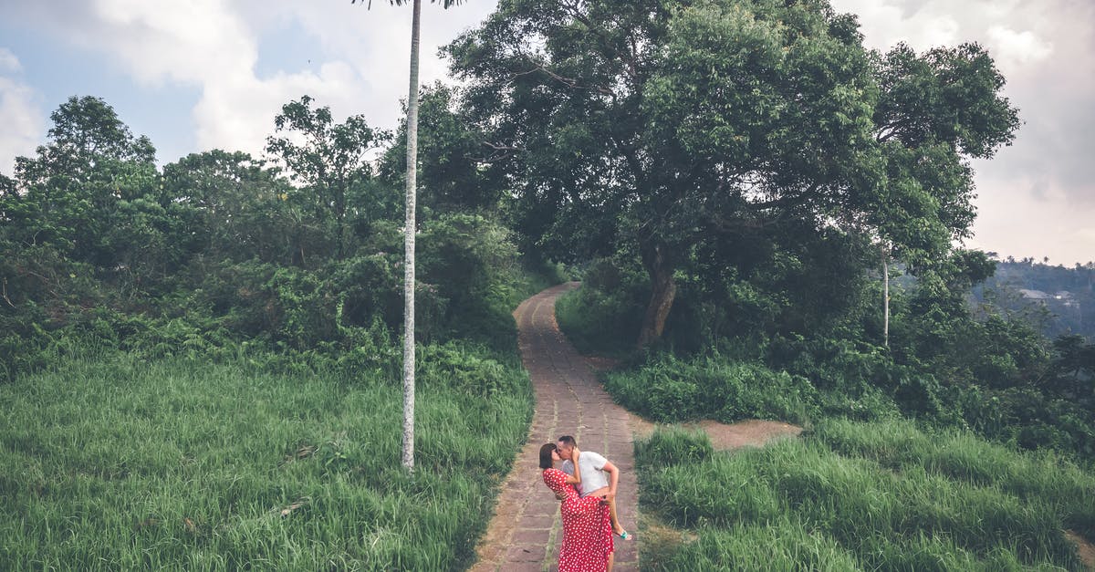 Travelling as unmarried couple in Indonesia [duplicate] - Man Kissing Woman Wearing Red Dress