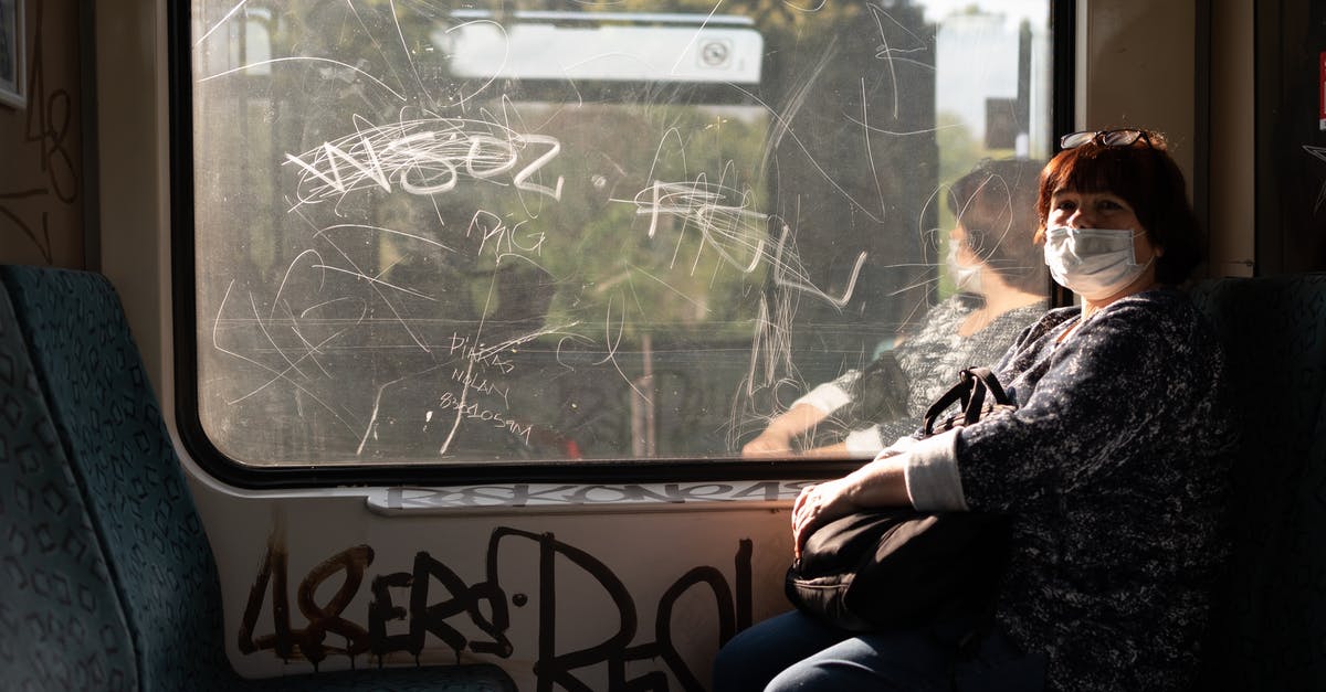 Travelling Europe by Train [closed] - Woman in Black Jacket Sitting on Bench