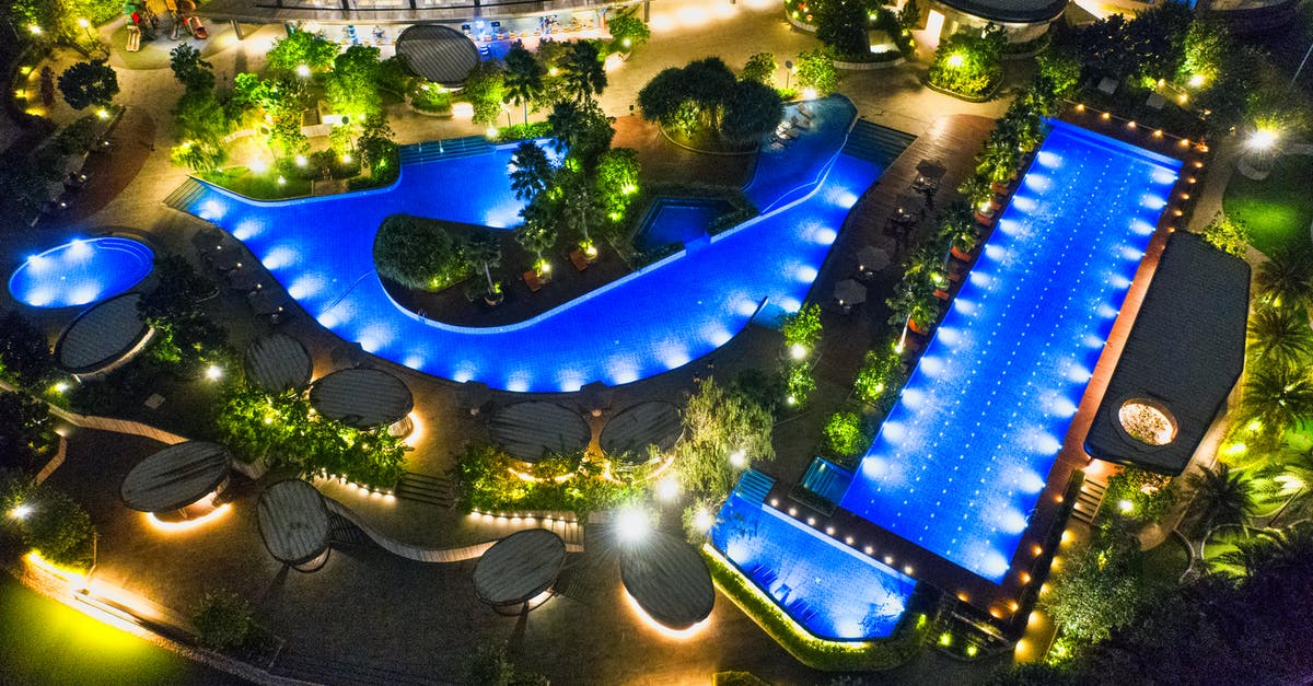 Travelling from Indonesia to New Zealand [duplicate] - Aerial Photo of Illuminated Outdoor Swimming Pools In Various Shapes At Night