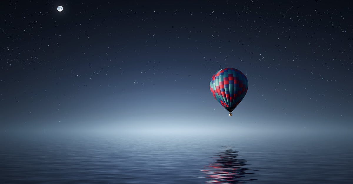 Travelling from the UK to the US but flying into Canada? - Red and Blue Hot Air Balloon Floating on Air on Body of Water during Night Time