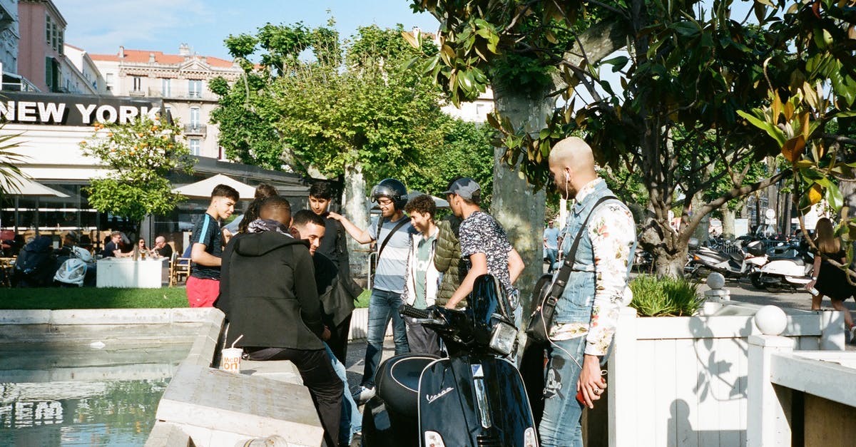 Travelling long-distance (Winnipeg – Auckland) with several stops as a blind person - People Standing Beside Black Motor Scooter