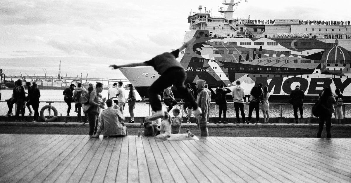 Travelling long-distance (Winnipeg – Auckland) with several stops as a blind person - Grayscale Photo of People on Pier