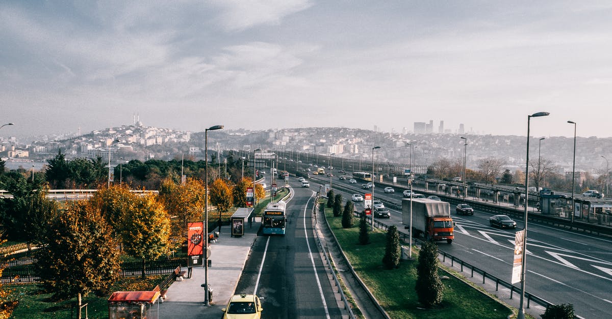 Travelling one way via boat, USA → Turkey - Multiple lane highway with driving vehicles located in Istanbul city suburb area on autumn day