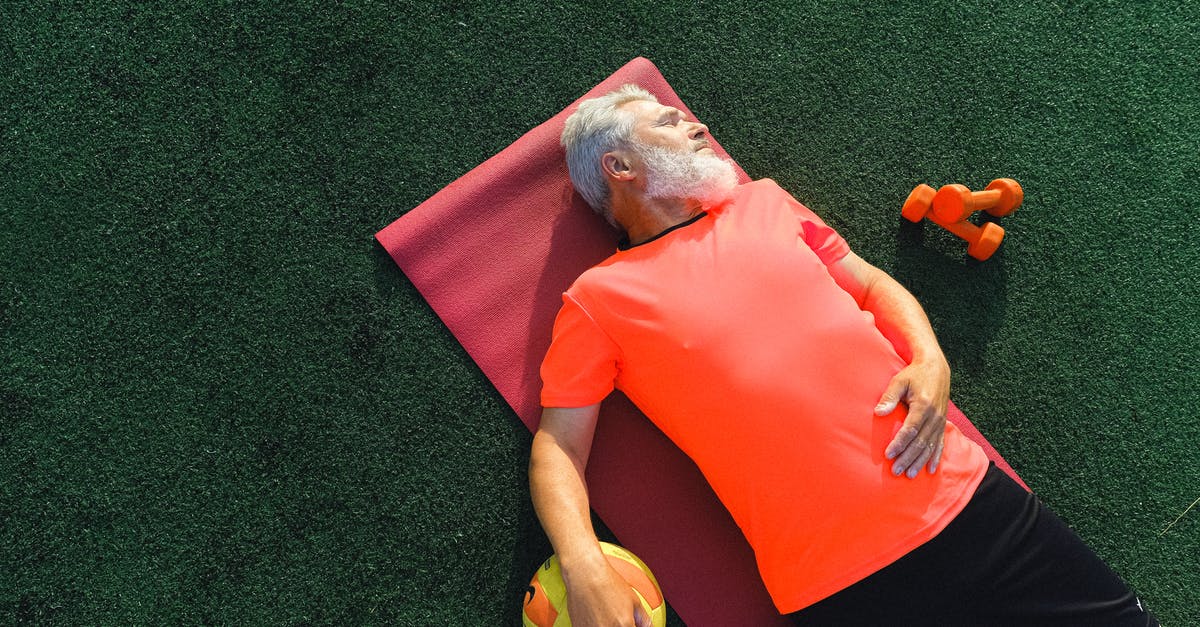 Travelling outside the USA while on Optional Practical Training (OPT) [closed] - From above of tired senior sportsman lying on fitness mat near ball and dumbbells and resting after training in sunny day