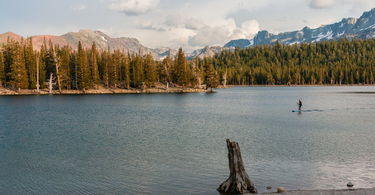 Travelling overland to Mammoth Lakes, California on a weekend - Man Riding on Paddle Board 