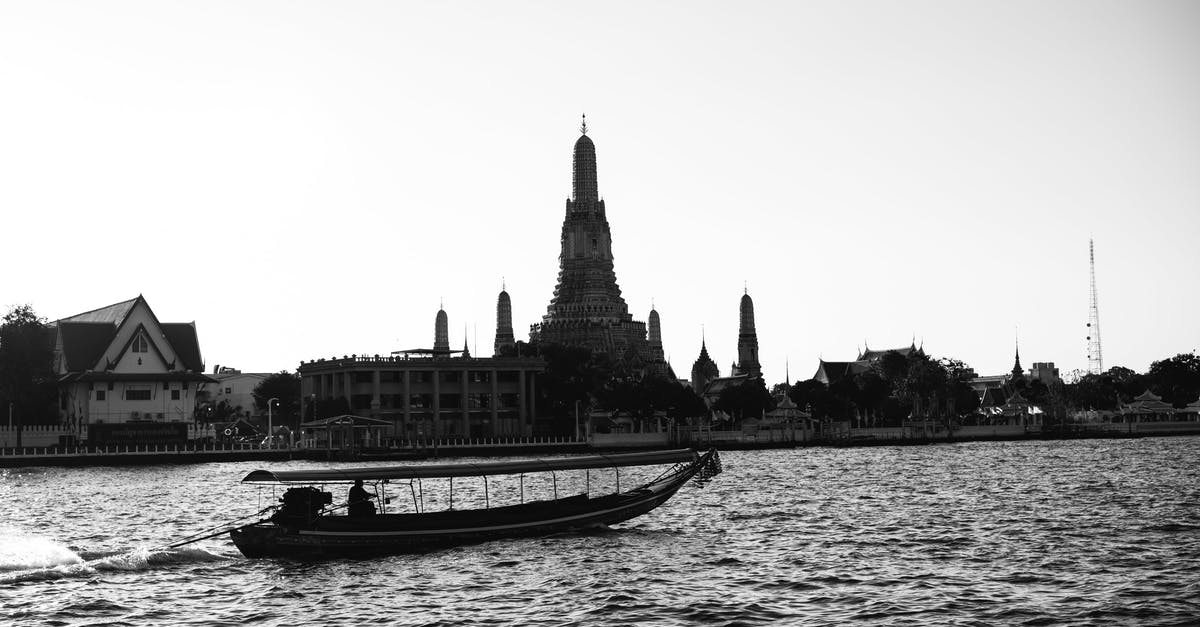 Travelling to Asia and Oceania with a peanut and pistachio allergy - Grayscale Photo of Boat on Water Near Building