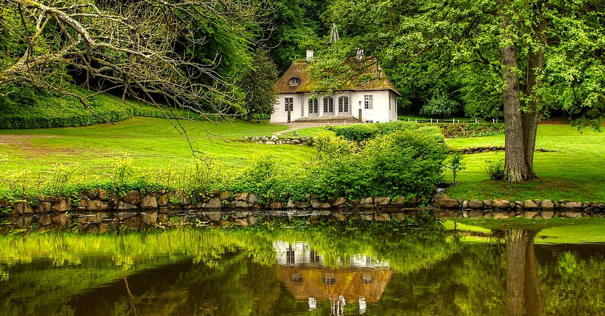 Travelling to Denmark with permit of stay receipt only - White and Brown House Surrounded by Trees