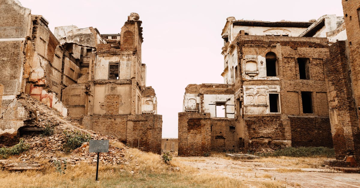 Travelling to Pakistan with expired NICOP - Person Sitting Beside Concrete Building