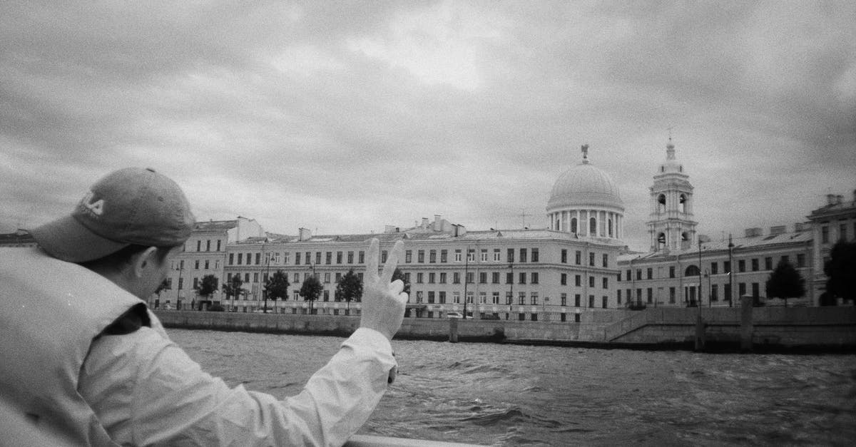 Travelling to Russia with engagement ring? - Grayscale Photo of Man Looking at the River