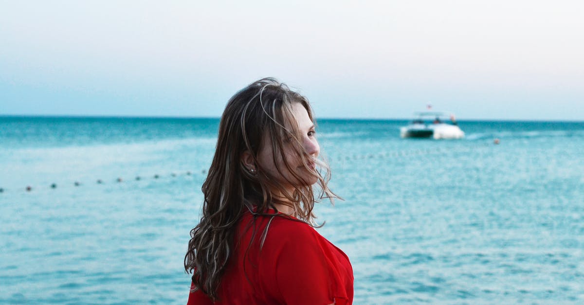 Travelling to Sakhalin Island and Kamchatka - Woman Standing in Front of Body of Water