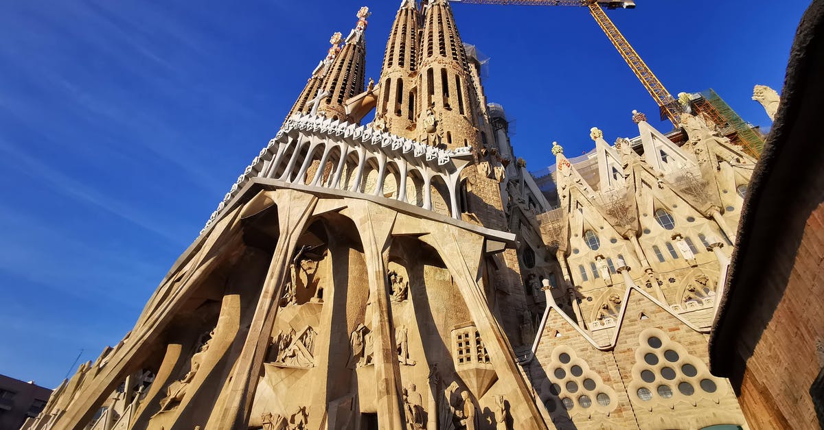 Travelling to Spain via London, Madrid or Barcelona [closed] - Brown Concrete Building Under Blue Sky