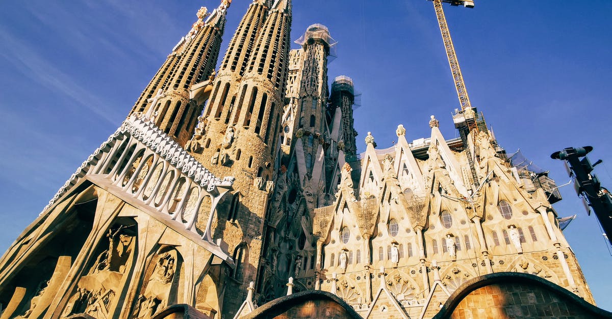 Travelling to Spain via London, Madrid or Barcelona [closed] - Brown Concrete Building Under Blue Sky