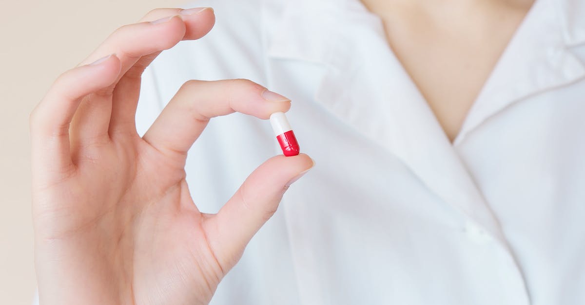 Travelling to the US with prescription medication Sertraline - Crop nurse demonstrating small double colored pill