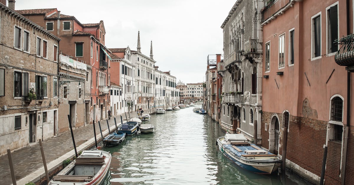 Travelling to Venice on All Saint's day - Waterway with gondolas amidst old medieval buildings