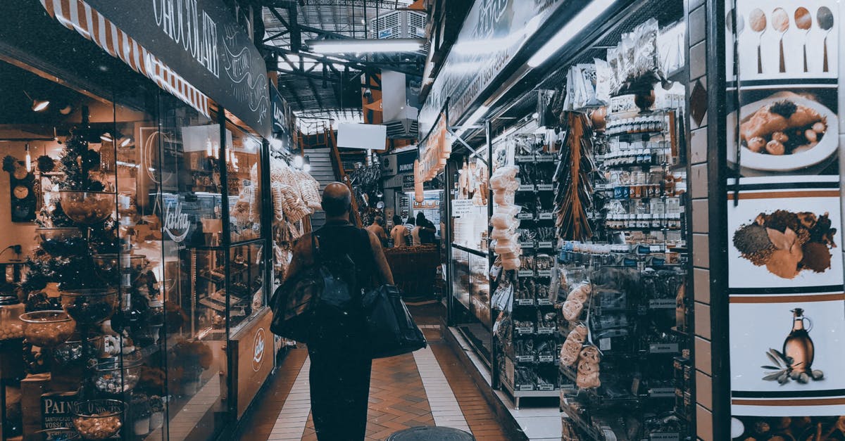 Travelling with 2 check-in bags - Person Standing on Pathway Near Store