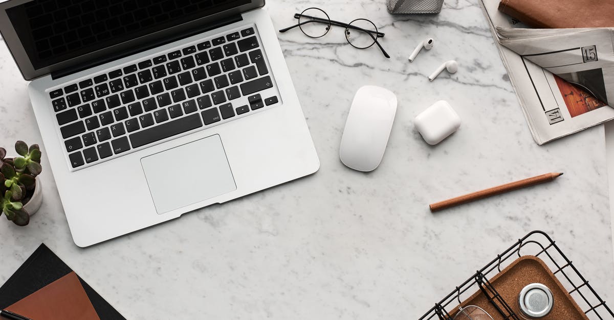 Travelling with a laptop - Flatlay Display of Electronics next to Eyeglases