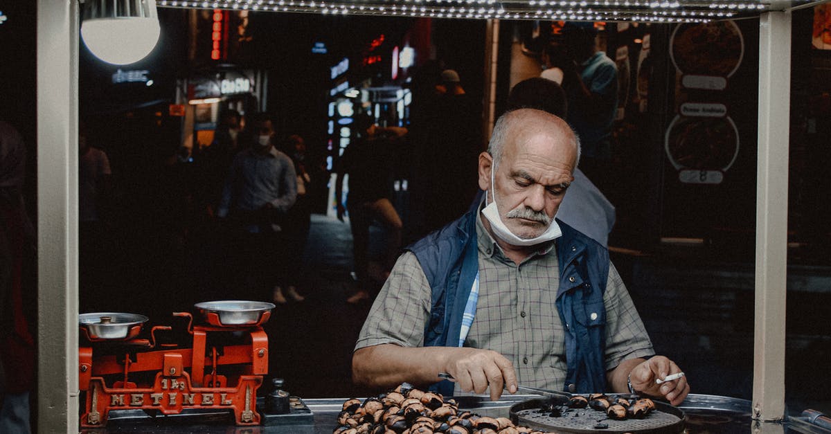 Travelling with EU with a receipt of carte de sejour - A Man Cooking on the Street