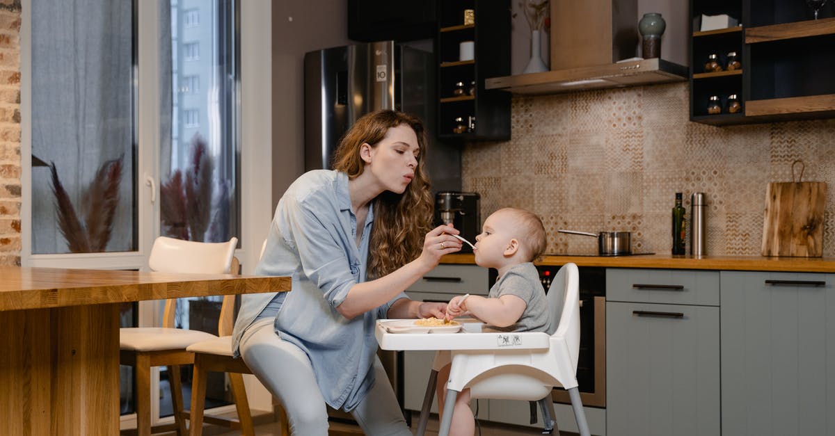 Travelling with Infant to Hong Kong - Need to use Kitchen - A Woman Feeding Her Baby Sitting on the High Chair