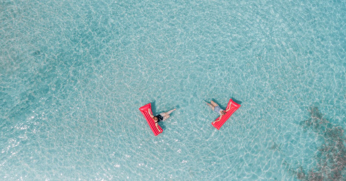 Tropical islands, Berlin, Germany. Inflatable "toys"? - People Lying on an Inflatable Floater on the Beach