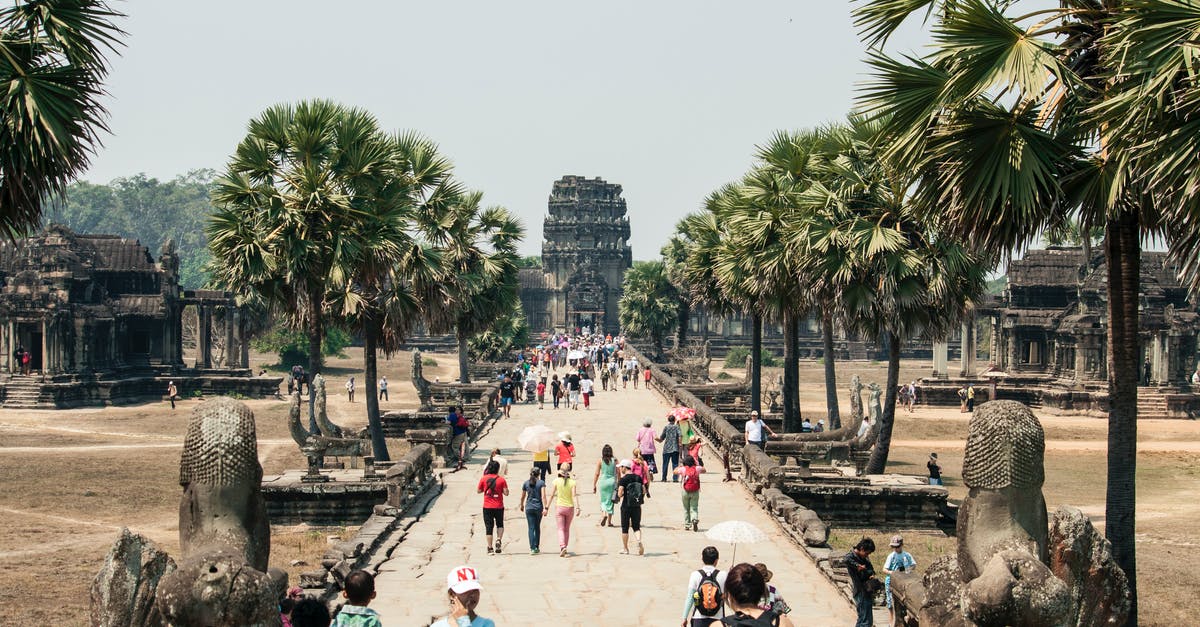 True current procedure and cost of extending Cambodia tourist visa in person? - Crowd of people strolling along paved walkway of ancient Angkor Wat in Cambodia