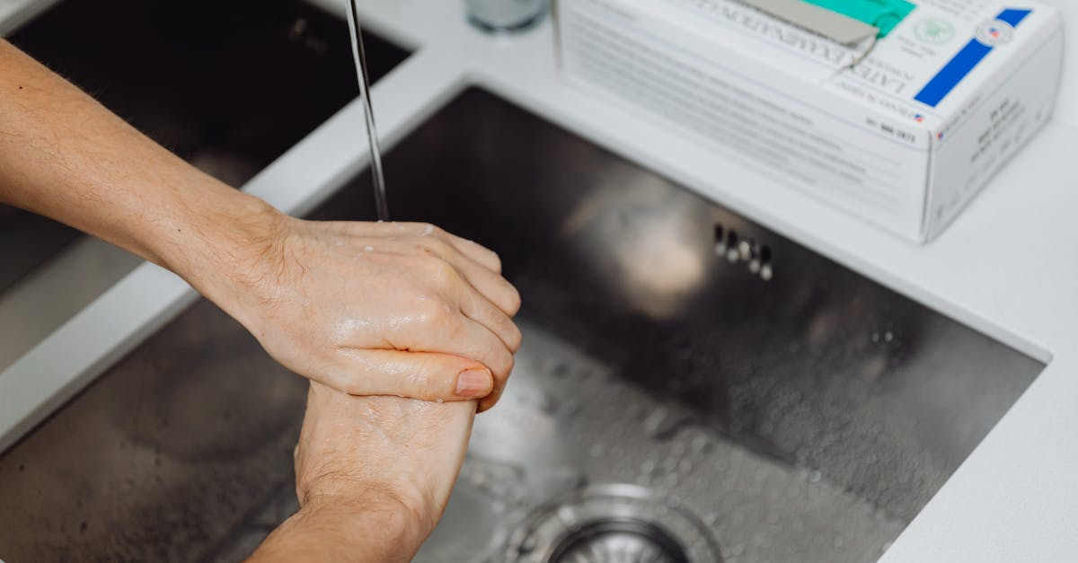 Truth about Georgian tap water - Persons Left Hand on Black Table