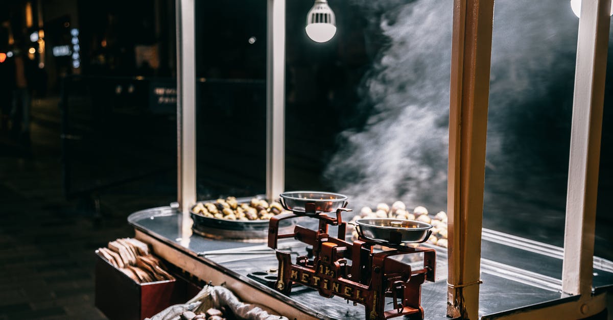 Trying local Romanian cuisine in Bucharest [closed] - Roasted chestnuts selling in food cart on street