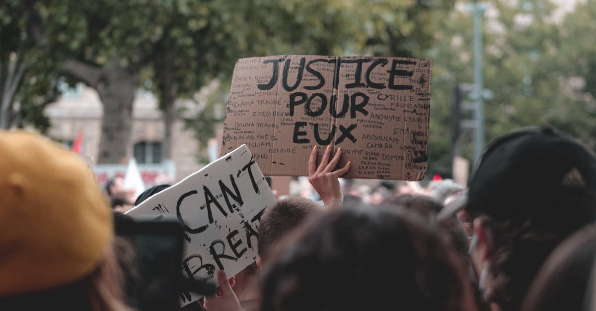 Trying to gather the right documents for my next application - Unrecognizable person at Black Lives Matter demonstration standing in crowd and protesting with handmade sign