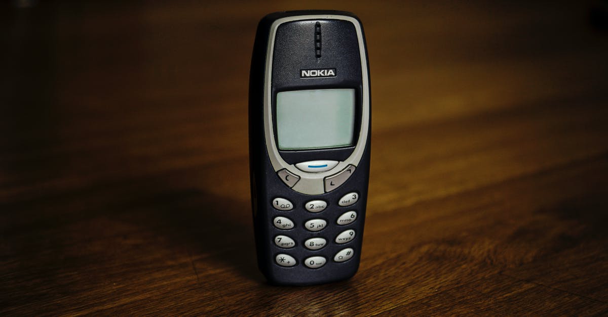 TSA asking to see cell phone - Retro cellphone with buttons placed on table