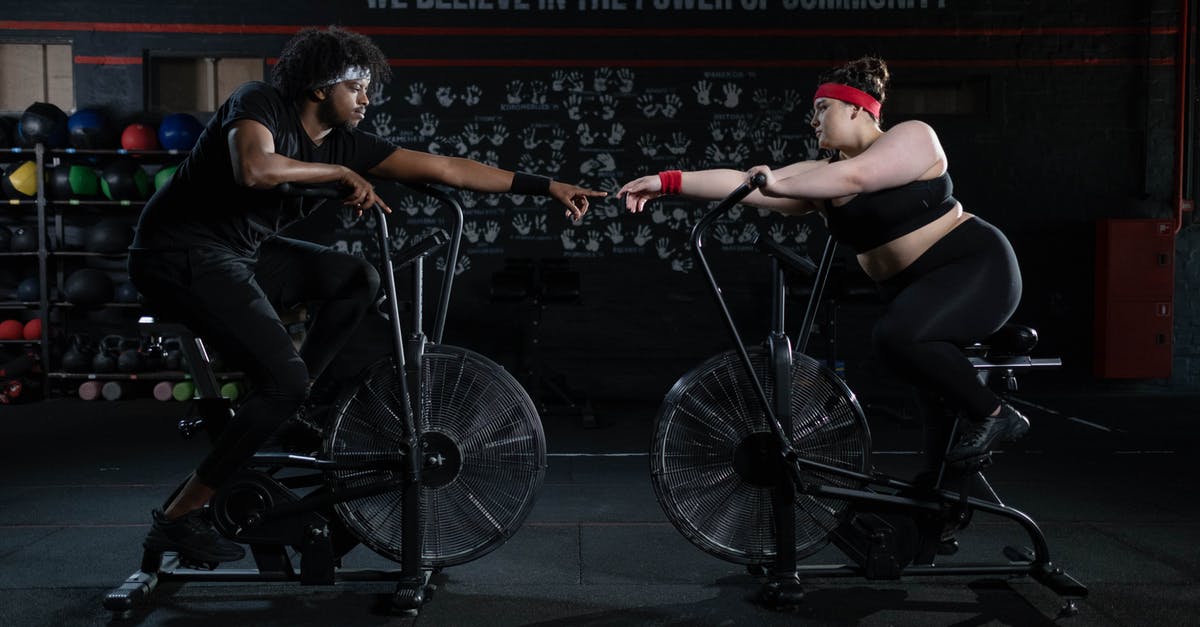 TSA Precheck on all connecting flights - Man and Woman Exercising Using a Stationary Bicycle